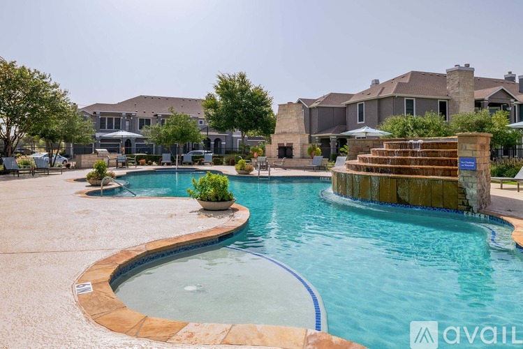 A large swimming pool with a hot tub in the middle of a residential area.