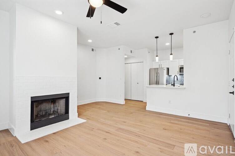 A modern living room with a fireplace and hardwood floors.