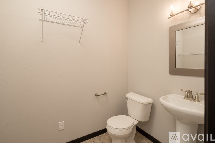 A white toilet sits next to a sink in a small bathroom.