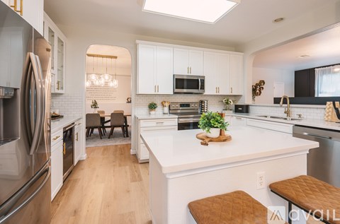 A modern kitchen with white cabinets and a large island.