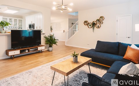 A living room with a blue couch and a television.