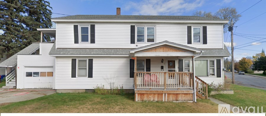 A two-story house with a porch and a garage.
