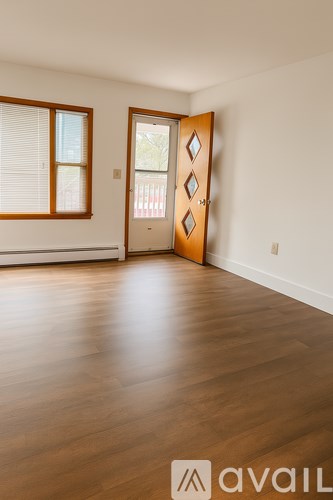 A room with wooden floors and a white door.