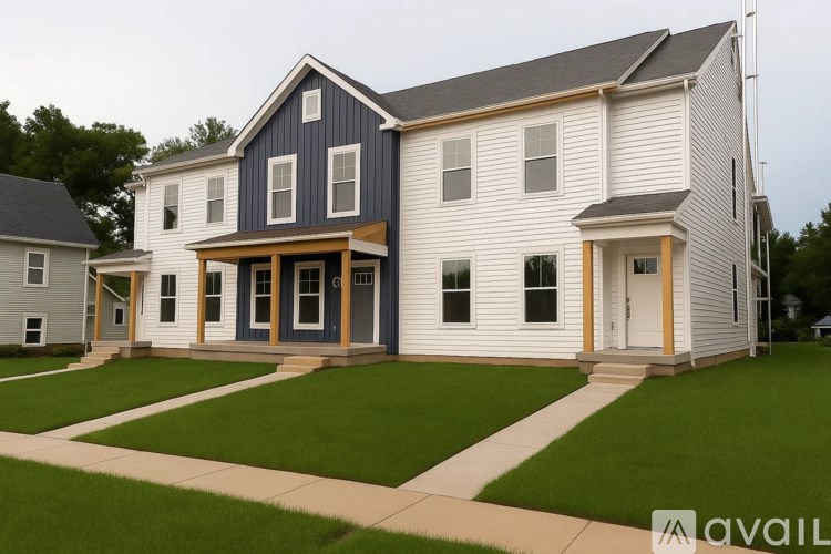 A two story house with a blue and white exterior.