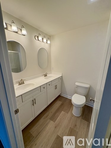 A room with a fan and two windows is under construction.