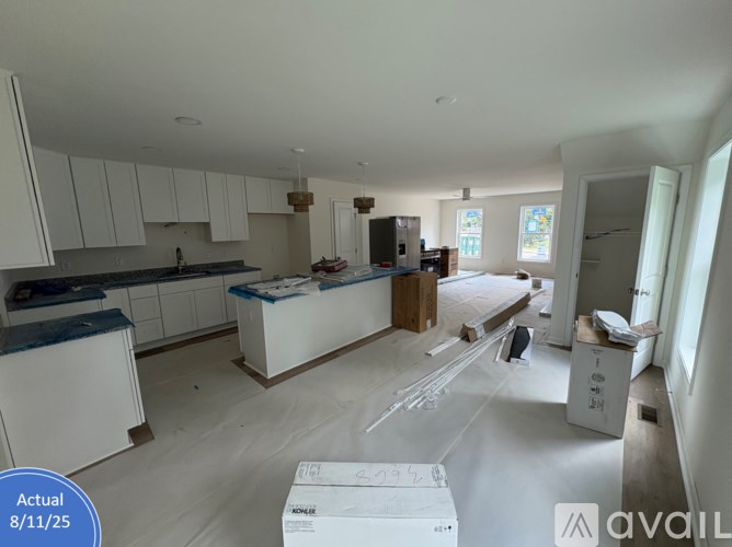 A kitchen under construction with cabinets and appliances in place.