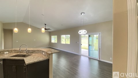 A kitchen with a granite countertop and a sink is available for viewing.