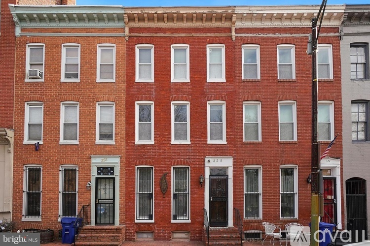 A red brick building with white windows and black doors.