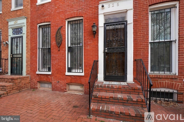 A red brick house with a black door and windows.