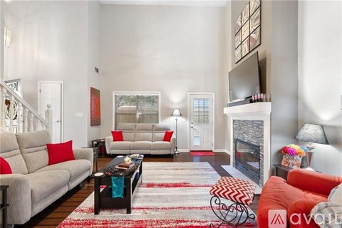 A living room with a red couch and a coffee table.