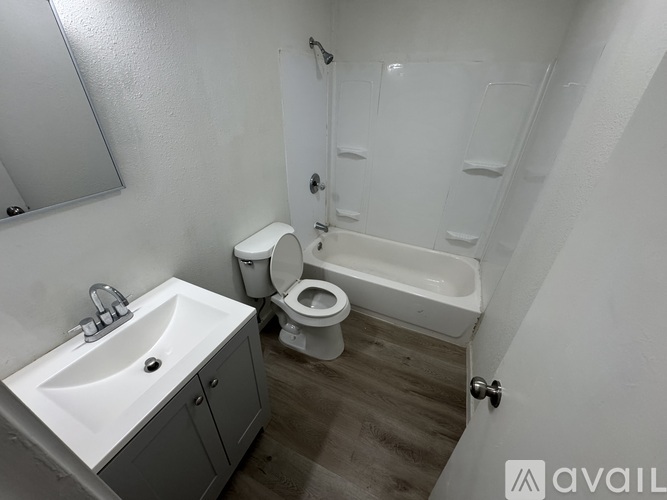 A bathroom with a toilet, sink, and bathtub.