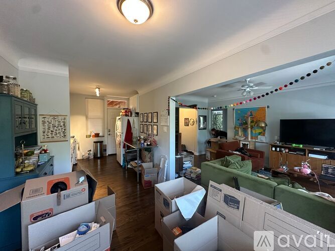 A room with boxes on the floor and furniture.