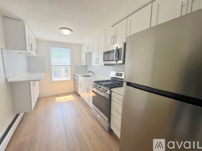 A kitchen with a stainless steel refrigerator, oven, and microwave.