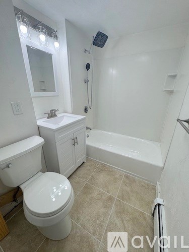 A white toilet sits next to a sink in a bathroom.