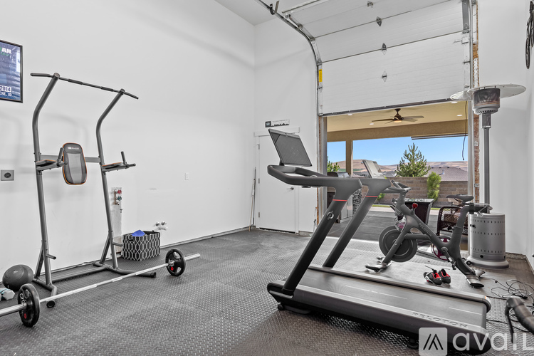A well equipped gym with a treadmill, weights and other equipment.