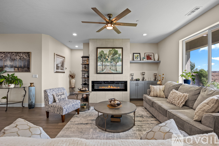 A living room with a fireplace and a painting on the wall.