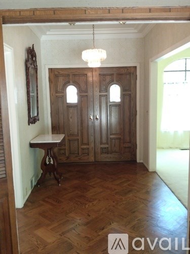 A room with a wooden floor and a wooden door.