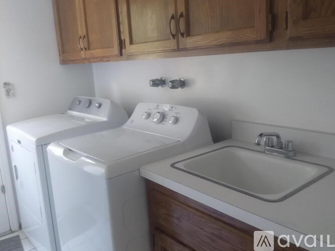 A white washing machine and dryer in a kitchen.