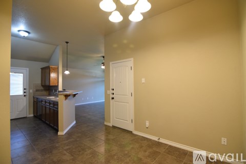 A kitchen area with a counter and cabinets is visible.