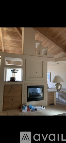 A living room with a television and a wooden cabinet.