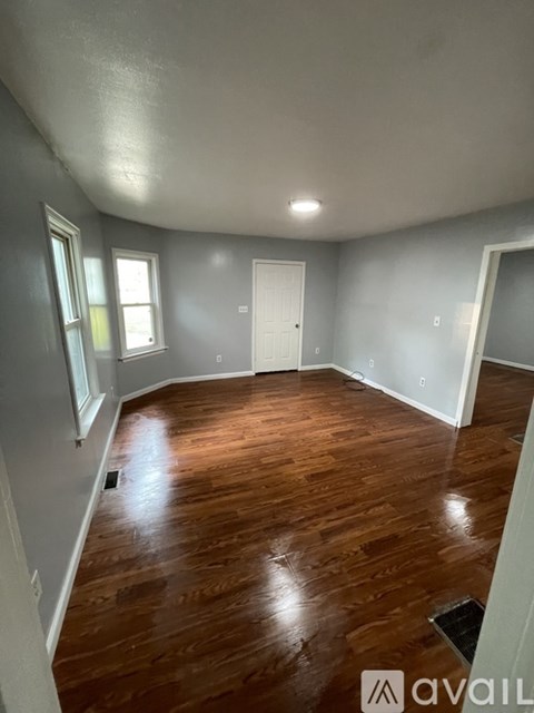 A room with wooden floors and white walls.