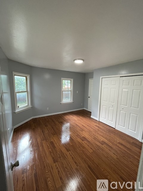 A room with wooden floors and white walls.