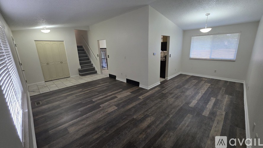 A backyard with a wooden fence and a house in the background.