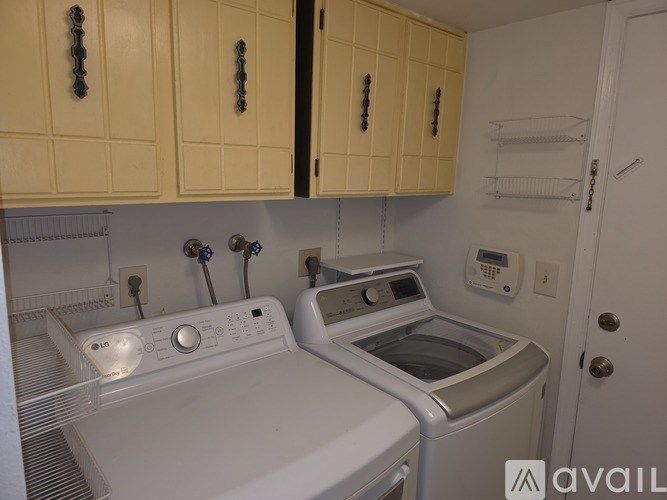 A small laundry room with a washer and dryer.