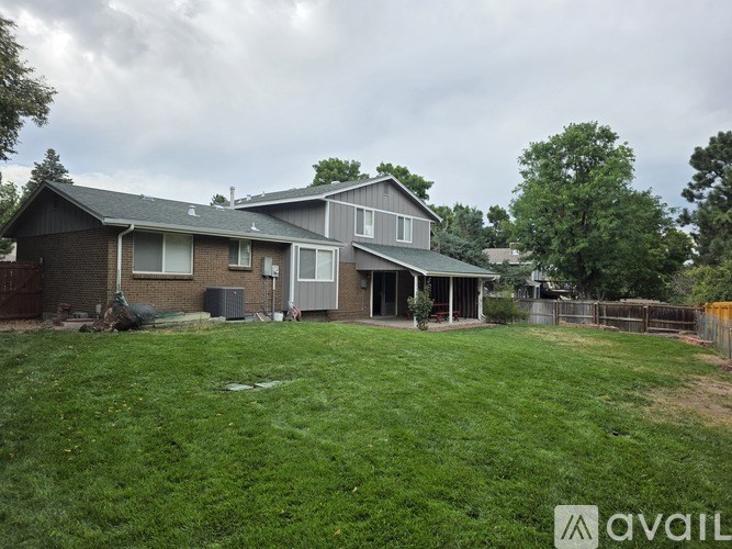 A house with a green lawn and a mailbox on the front.