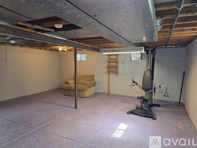 A room with a white door and a white wall with a wooden floor.