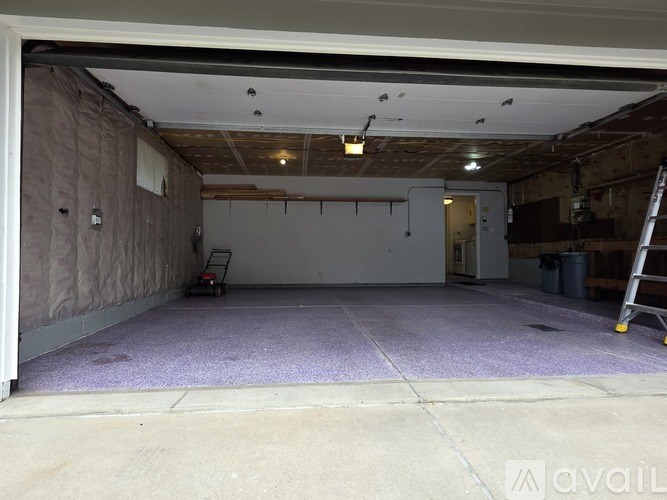 A room with a purple carpet and a window.