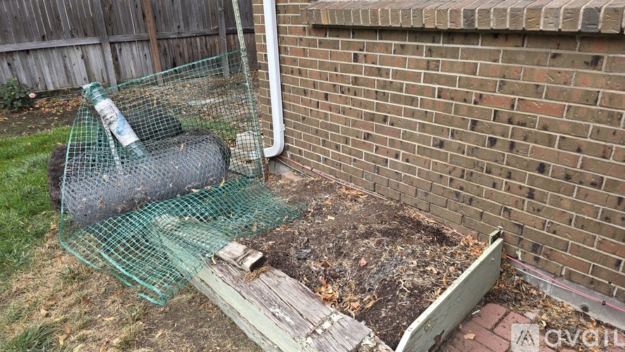 A kitchen with wooden cabinets and a black refrigerator.