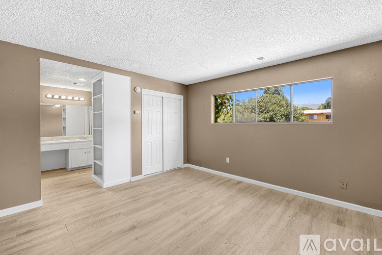 A room with a large mirror and a desk.