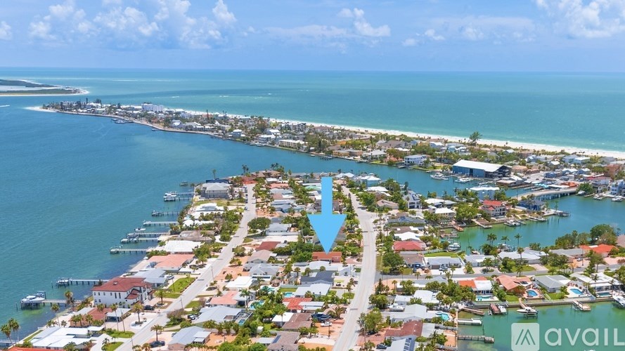 A house with a driveway and landscaping in front.