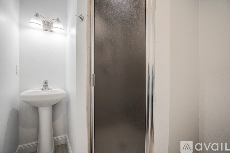 A living room with a couch, a coffee table, and a fireplace.