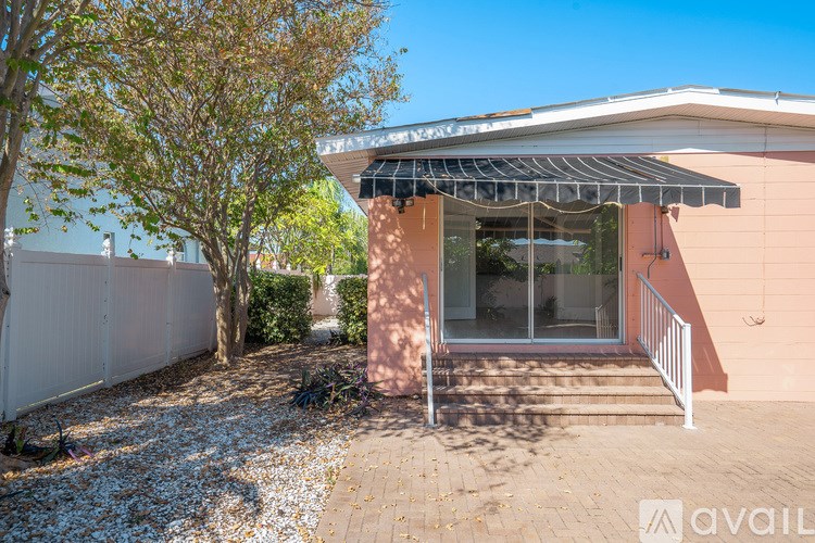 A house with a tree in front and a patio area.