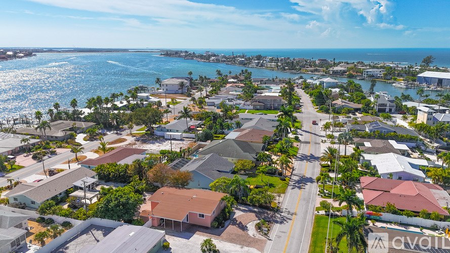 A bird's eye view of a residential area with houses and palm trees.