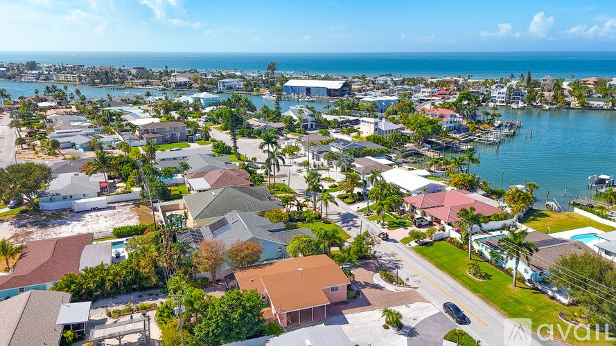 A bird's eye view of a residential area with houses and a body of water.