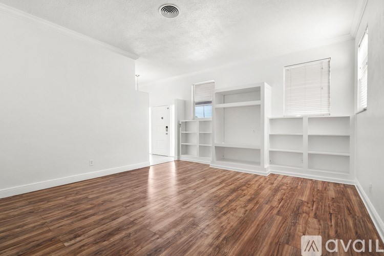 A kitchen with white cabinets and appliances.