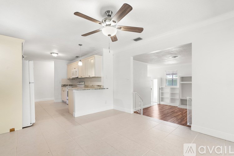 A bedroom with a bed, dresser, and window.