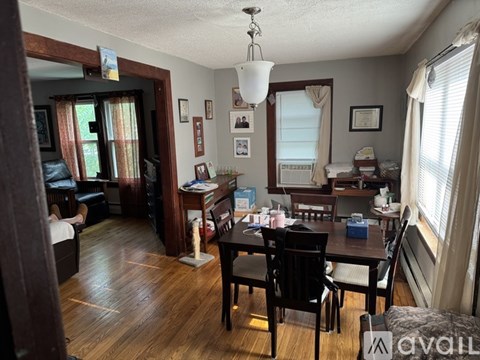 A living room with a dining table and chairs.