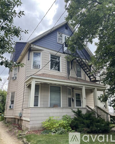A house with a blue roof and a staircase leading to the second floor.