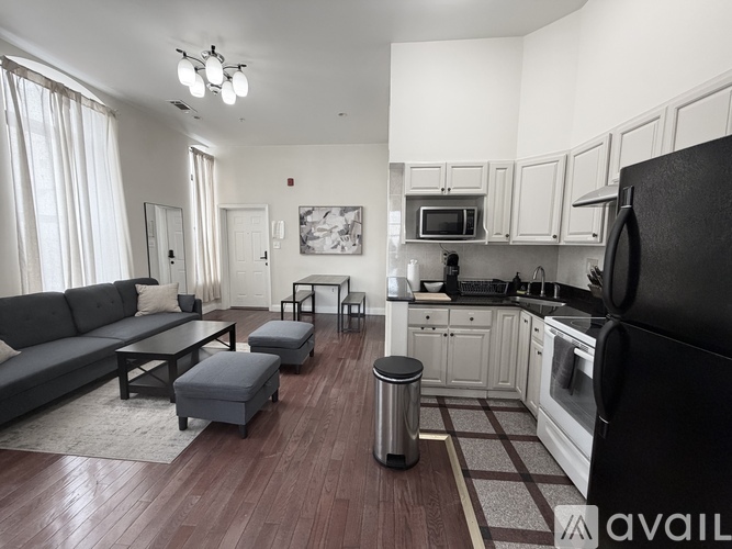 A kitchen with a dining table and chairs in the middle of the room.