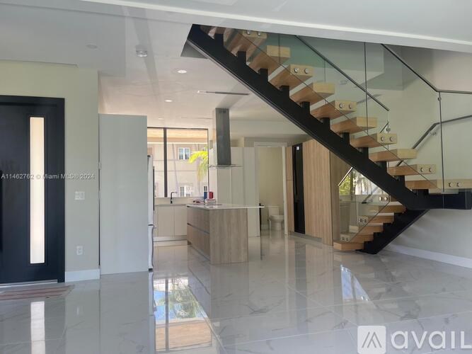 A modern interior with a glass staircase and a marble floor.