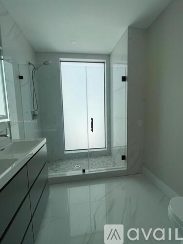 A bathroom with a walk in shower and a toilet.