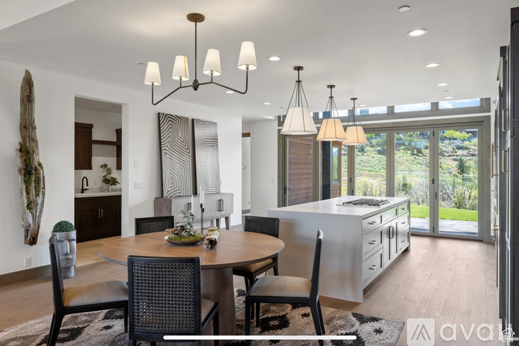 A modern dining room with a wooden table and chairs.