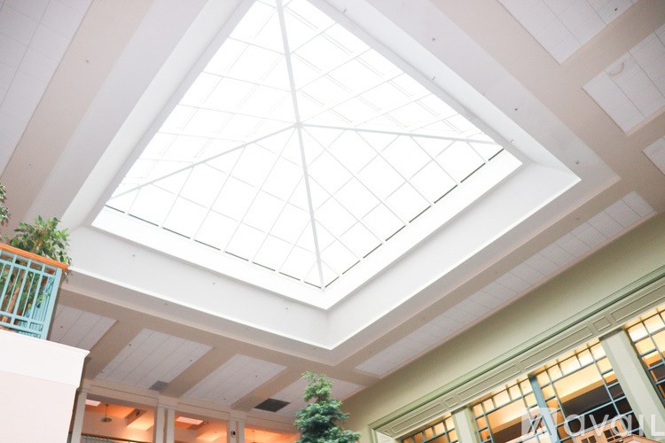 A white ceiling with a diamond patterned skylight.