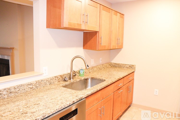 A kitchen with wooden cabinets and granite countertops.