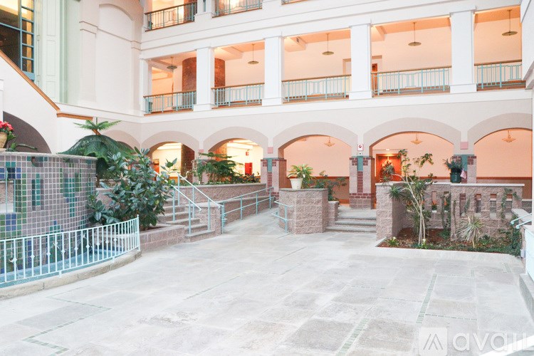 A courtyard with a fence and plants.