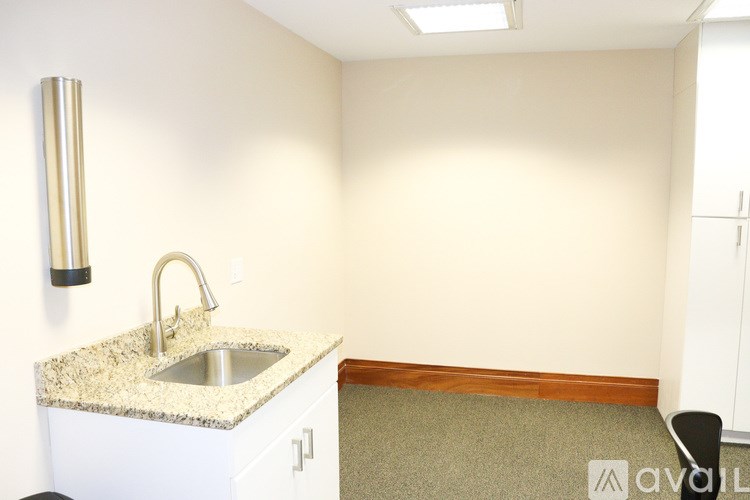 A kitchen with a granite countertop and a sink.